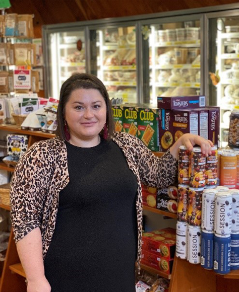 Owner of By the Spoonful standing in the store.