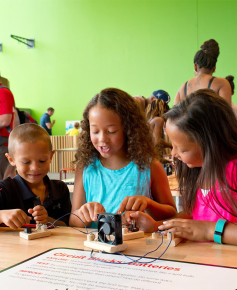 Children doing an experiment together at a table.