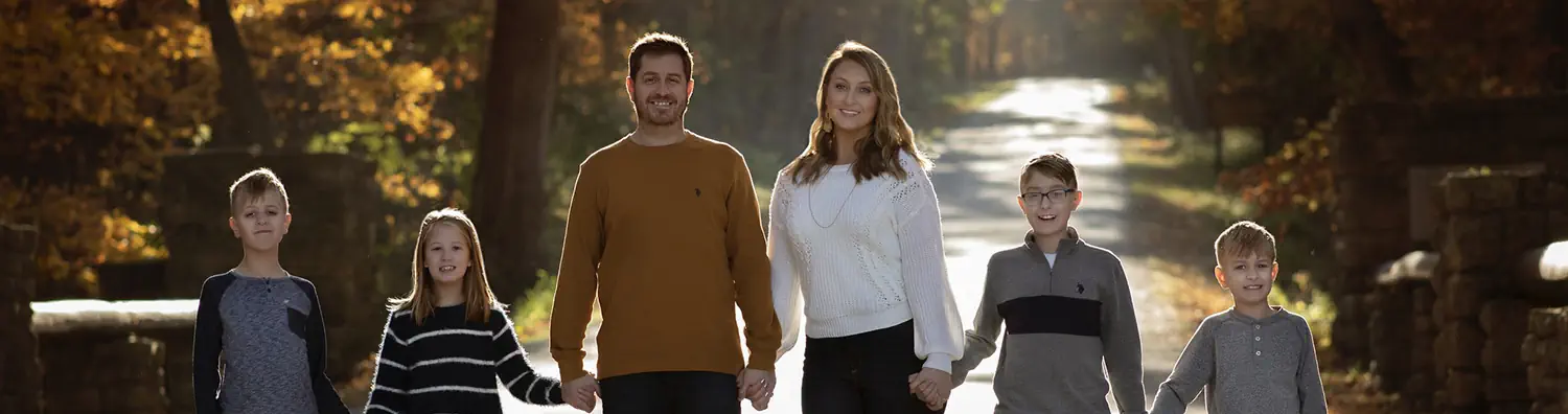 Cherie Edilson holding hands with her family in the road.