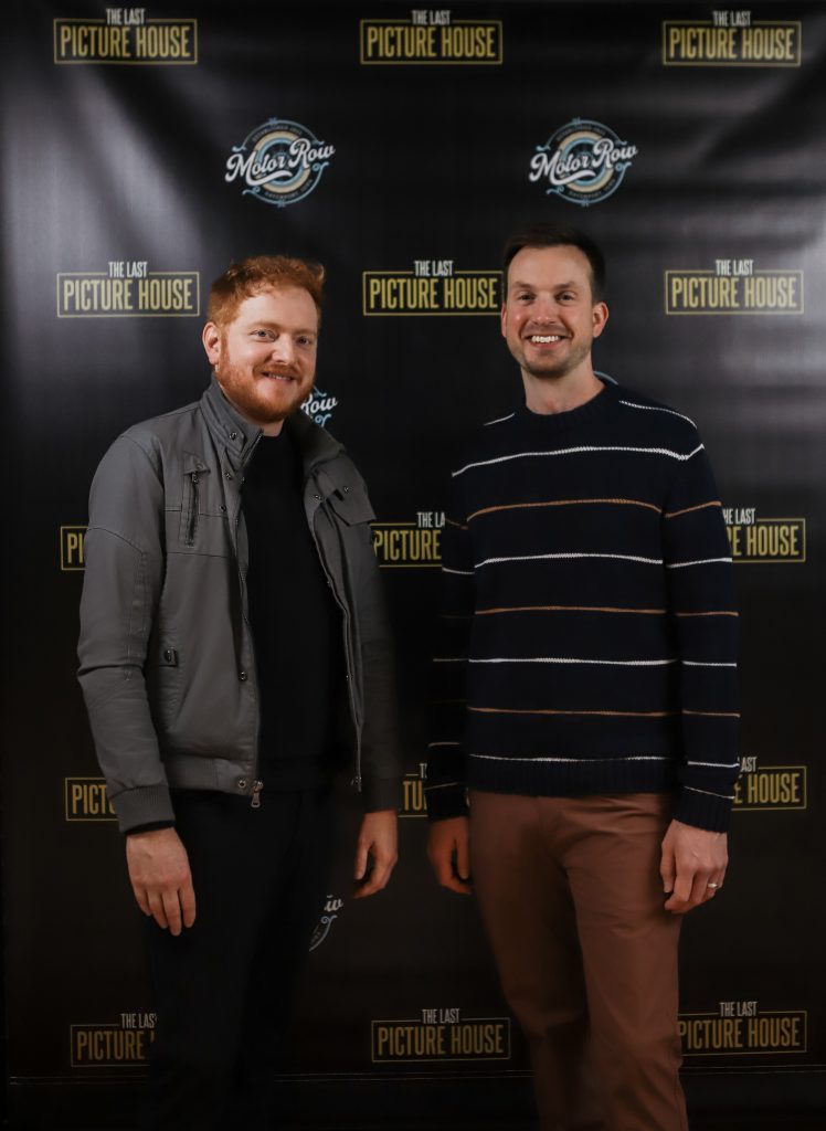 Bryan Woods and Scott Beck stand in front of a Last Picture House banner