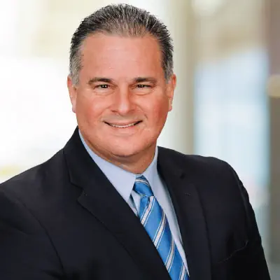 Headshot of Jeff Bloemker, wearing a suit and smiling.