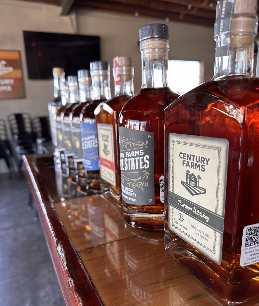 A row of whiskey bottles sit on top of the bar.