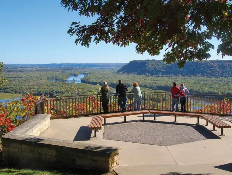 Group of people overlooking the view from the Pikes Peak State Park octagon.