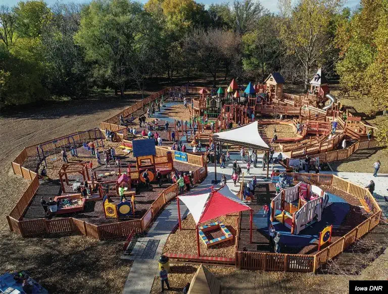 Families playing on the Dream Playground in Council Bluffs.