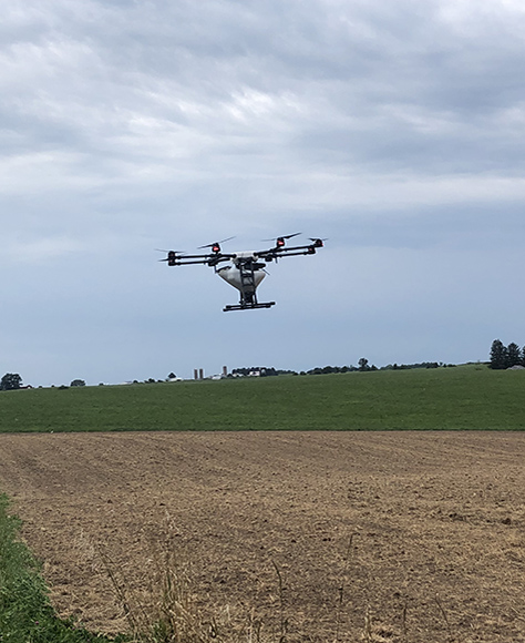 drone flying over farm land.