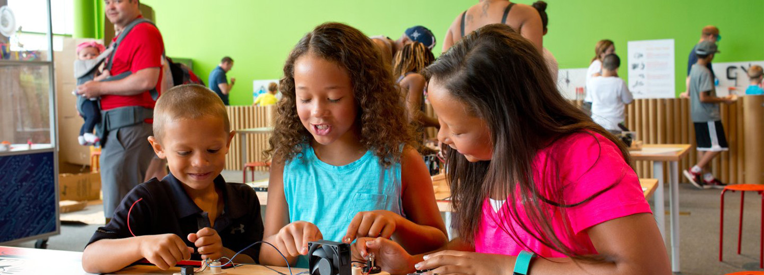 Kids at a table working on a project.