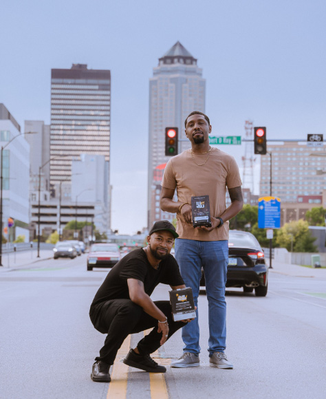 BLK & Bold founders holding boxes of their coffee.