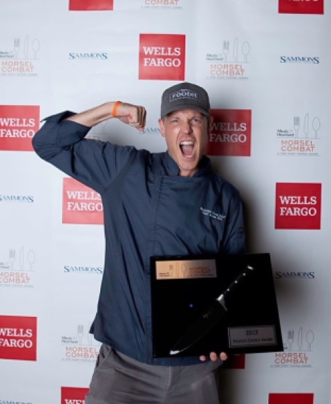 Aaron Holt holding an award