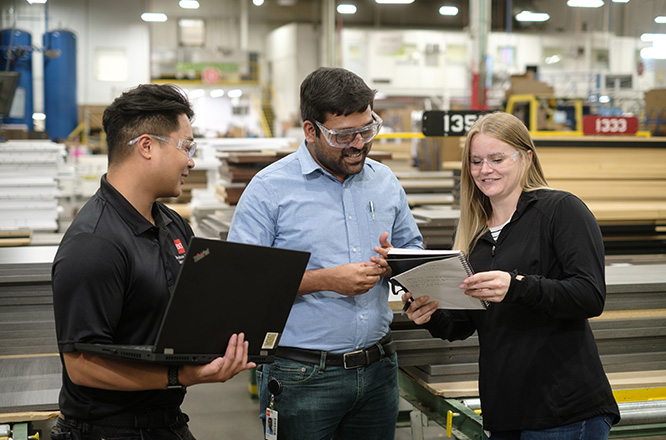 Three people collaborating together on some work.