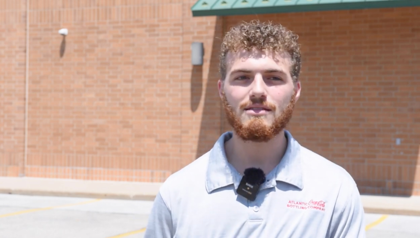 Marine veteran Sage Evans stands outside a store where he was stocking products